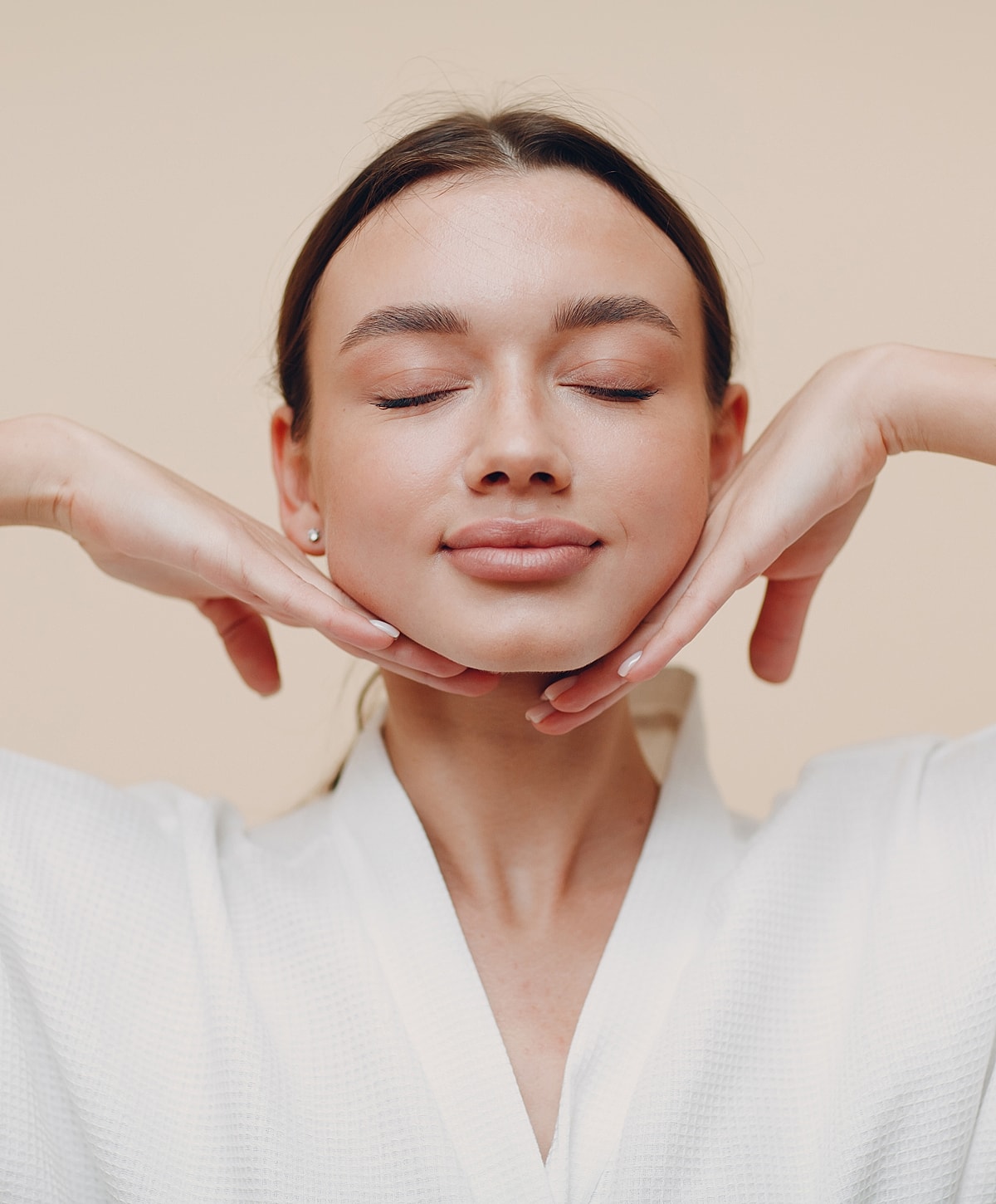 Smiling Kalispell acne treatment model with closed eyes, smiling gently.