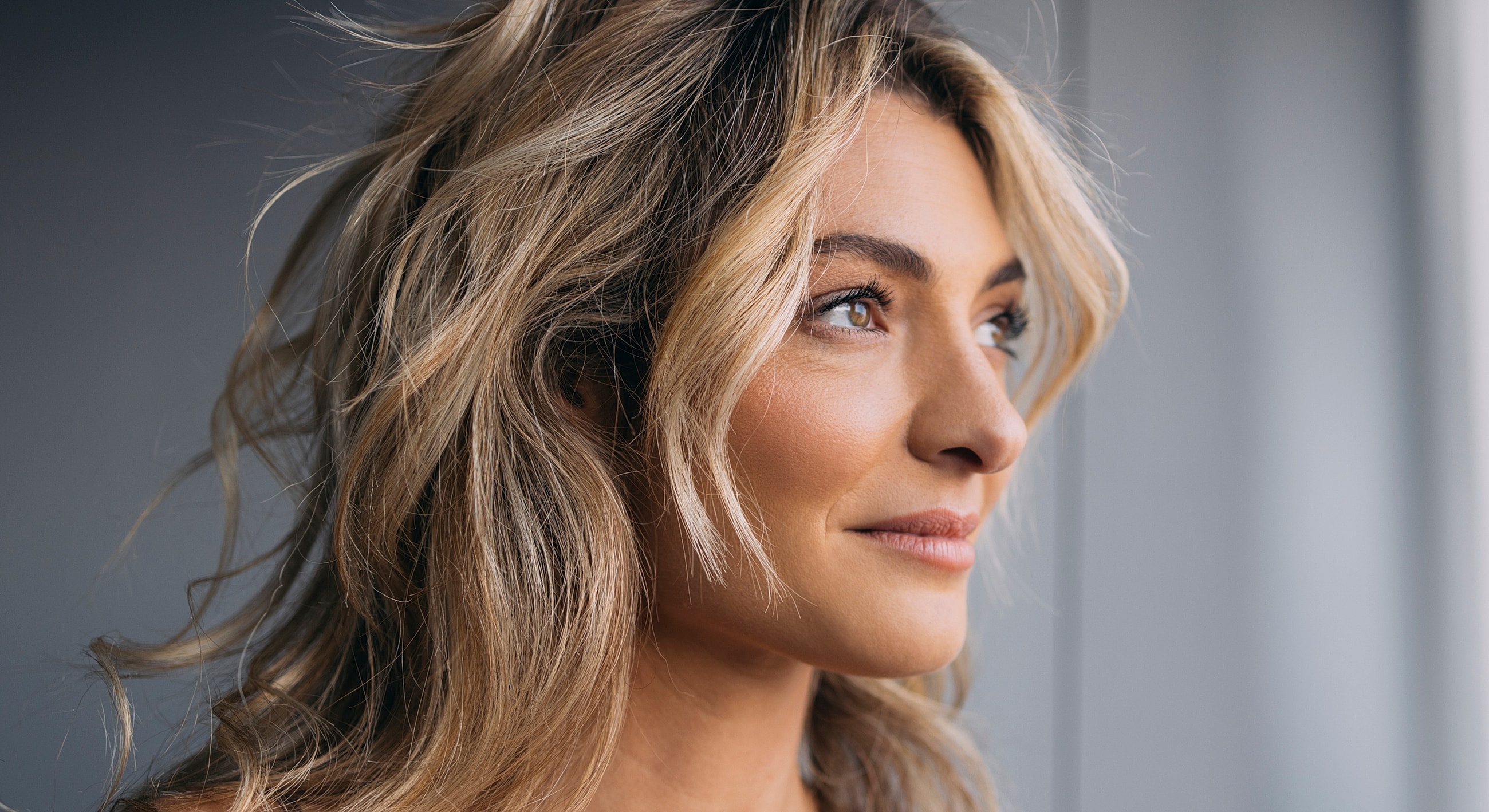 Warm portrait of a woman with flowing hair.