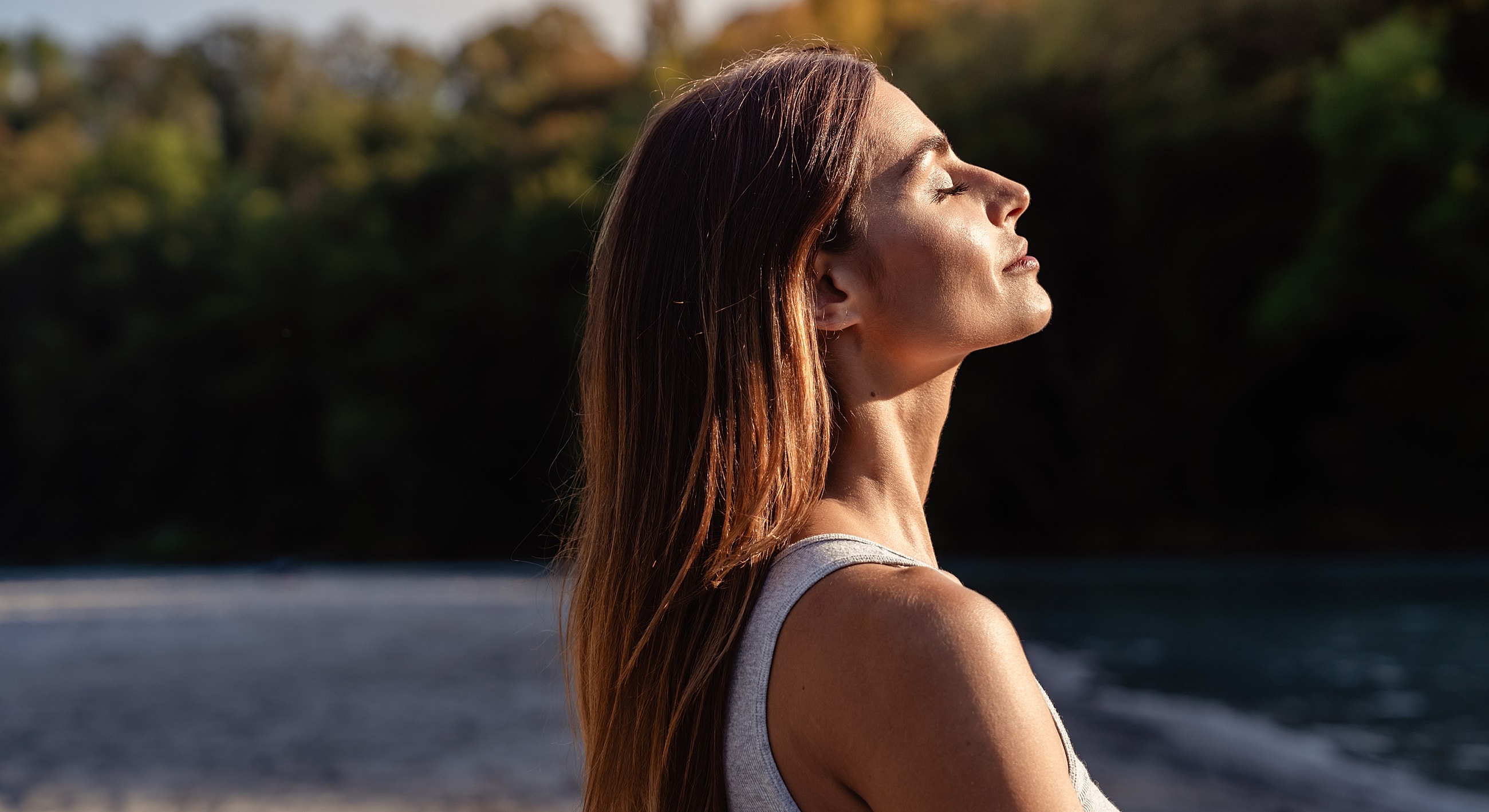 Karispell Botox facial model enjoying nature with eyes closed.